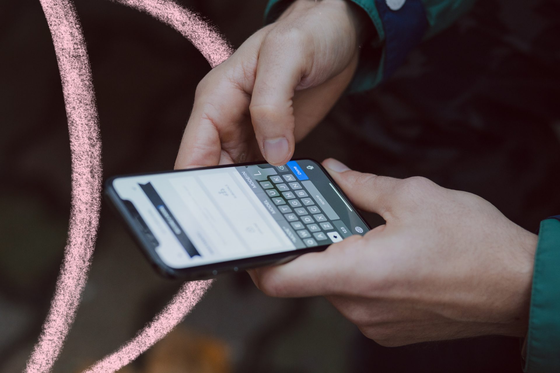 the photo shows a close up of a pair of hands holding a mobile phone