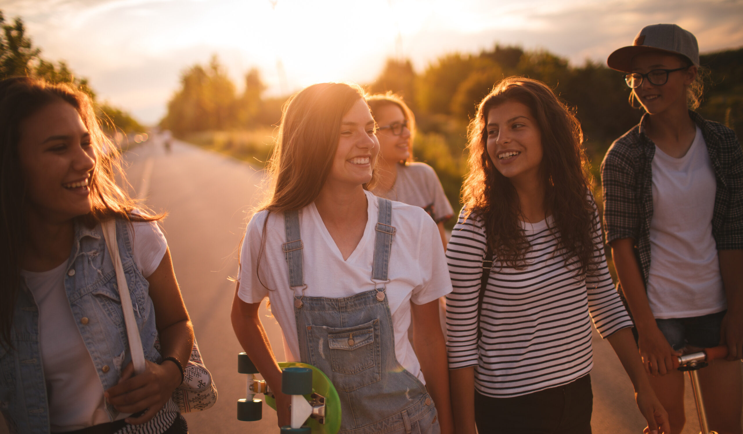 a group of teenage girls are walking outside together and smiling